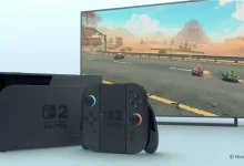 Console Nintendo Switch 2 noire avec Joy-Con détachés, devant un écran affichant un jeu de course.